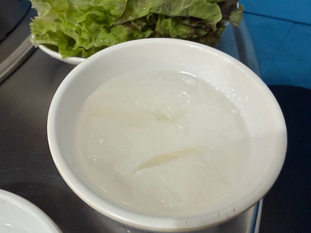 Bowl of dongchimi water kimchi broth served as a palate cleanser