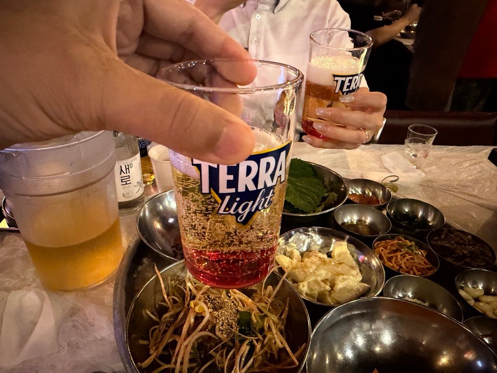 Glass of somaek soju-beer cocktail on a restaurant table
