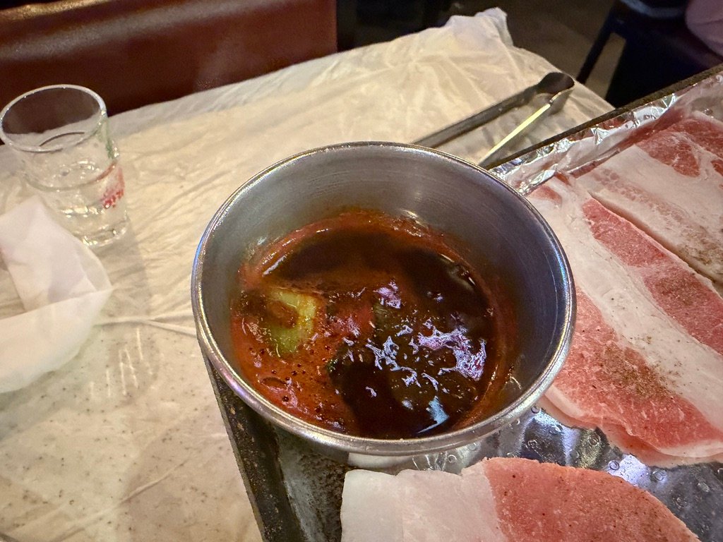 Fermented anchovy sauce served as a dipping condiment for samgyeopsal