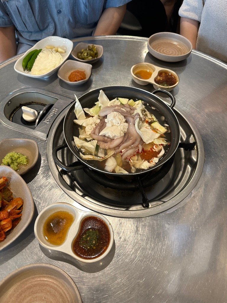 Bowl of octopus and tofu soup served as a welcome dish