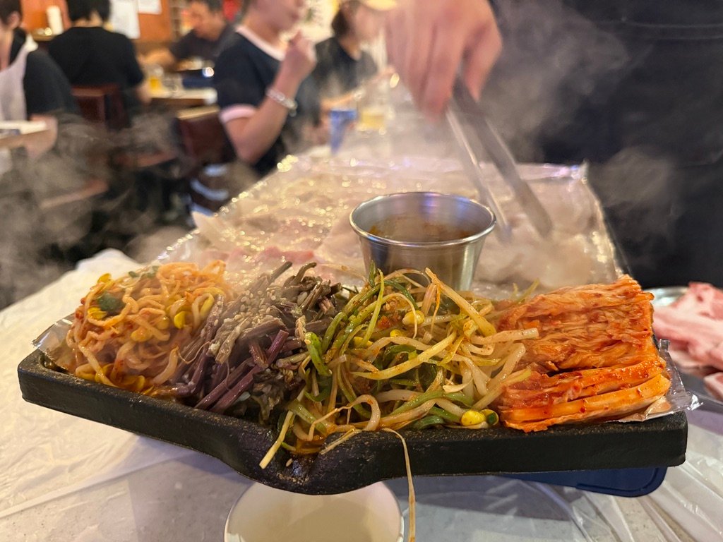 Grilled bean sprouts and scallions served with samgyeopsal