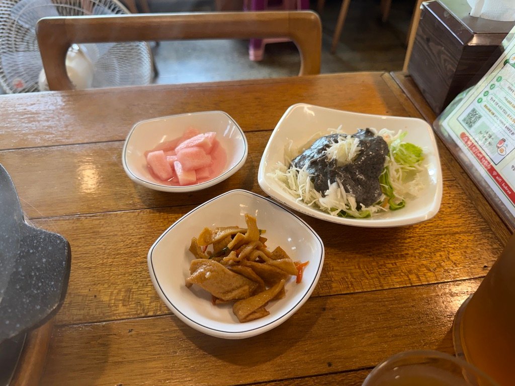Table spread of side dishes at Boklaene Budae-jjigae