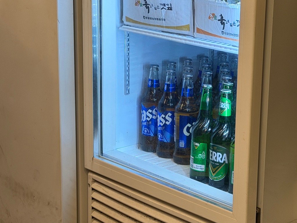 Refrigerator stocked with Cass and Terra beer at a Korean restaurant