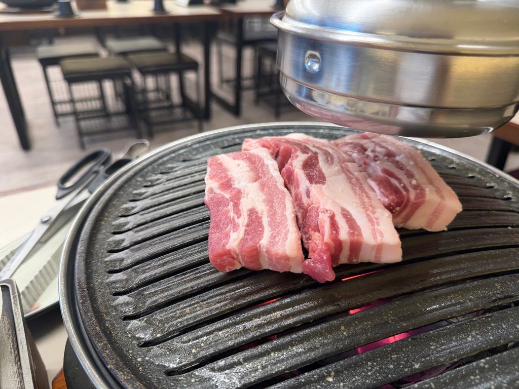 Raw samgyeopsal pork belly before grilling at a Korean BBQ restaurant