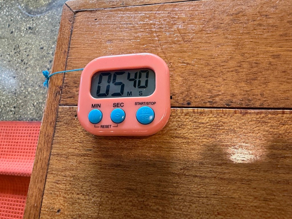 Pink kitchen timer used to time the budae-jjigae cooking process