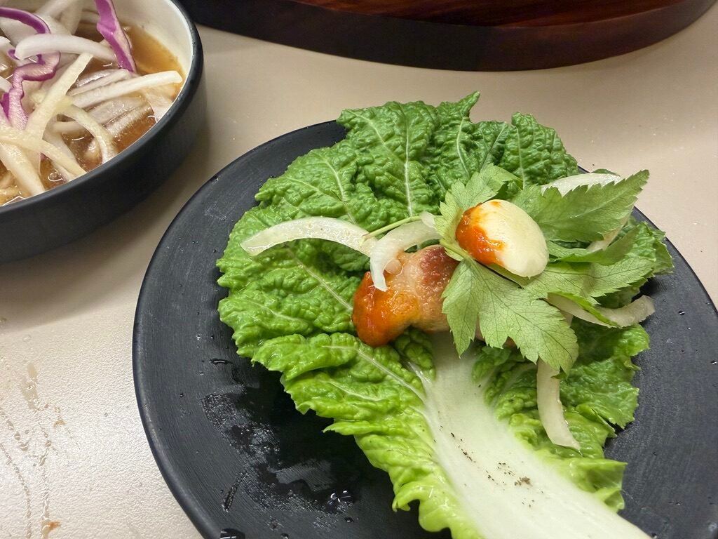 Samgyeopsal wrapped in lettuce and perilla leaves