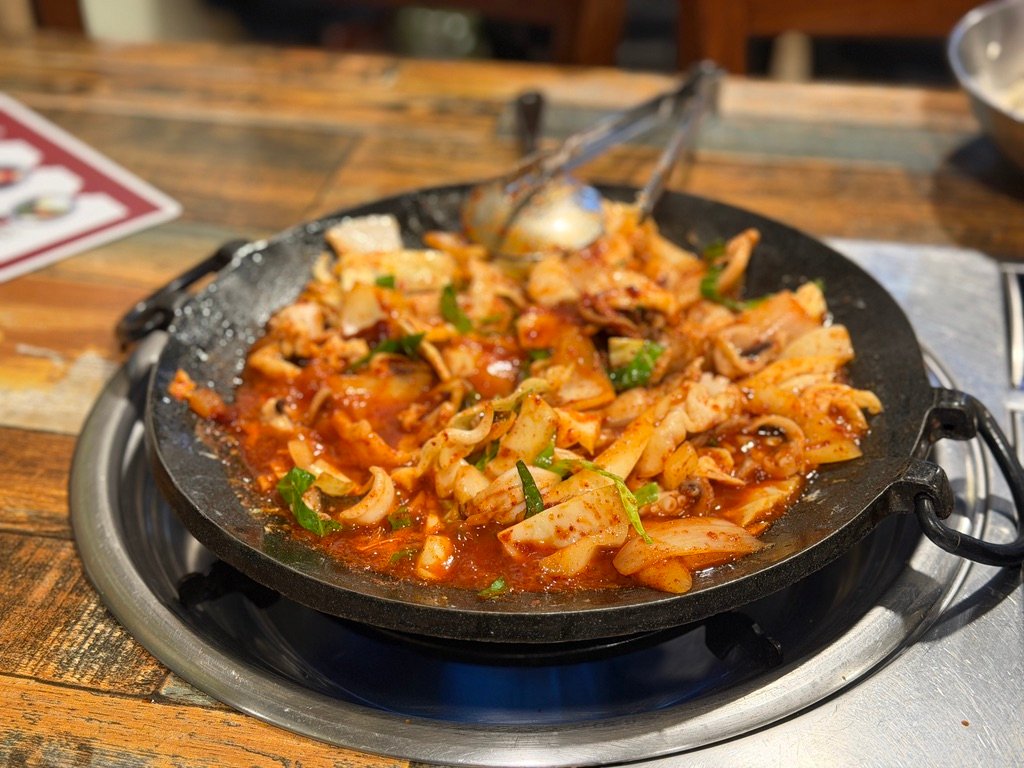 Combo platter of chukkumi and pork belly arranged on a griddle