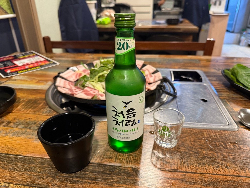 Soju served alongside spicy chukkumi at a Korean restaurant