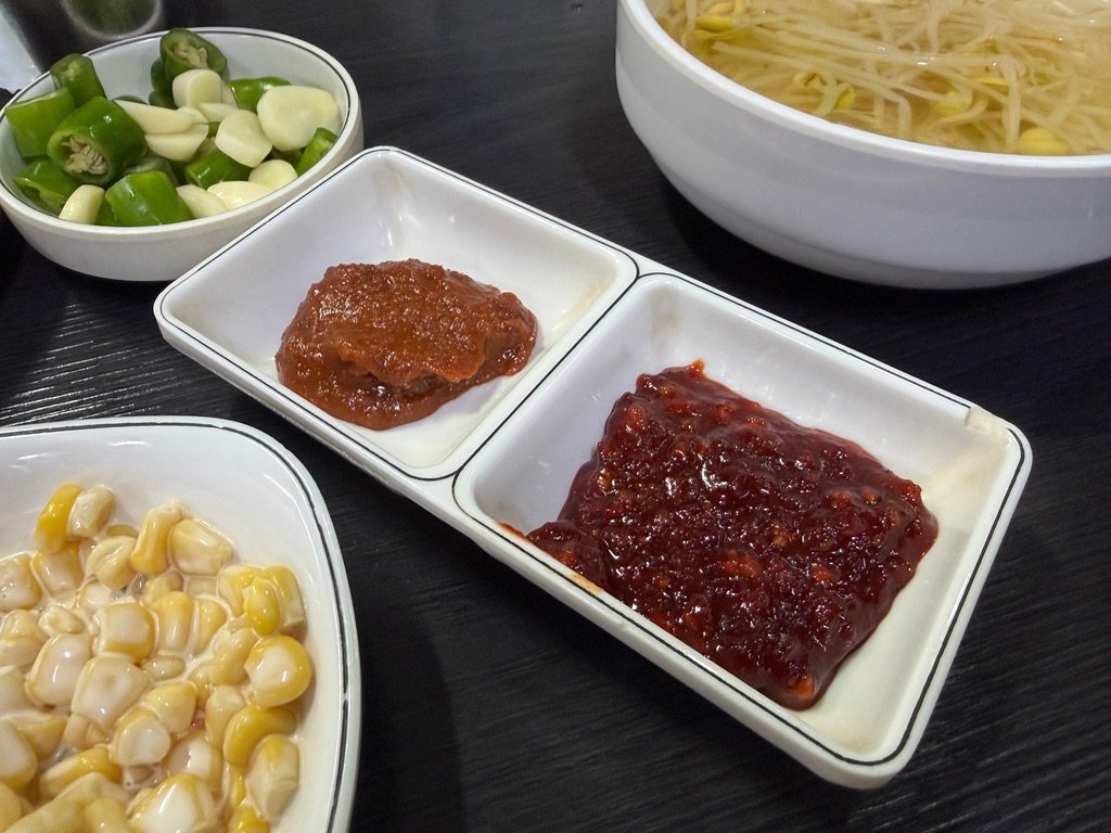 Two dipping sauces served alongside grilled gopchang