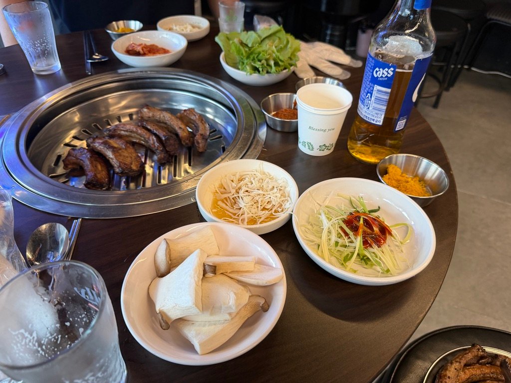 Side dishes served with deungalbi including pickled mushrooms and scallion salad