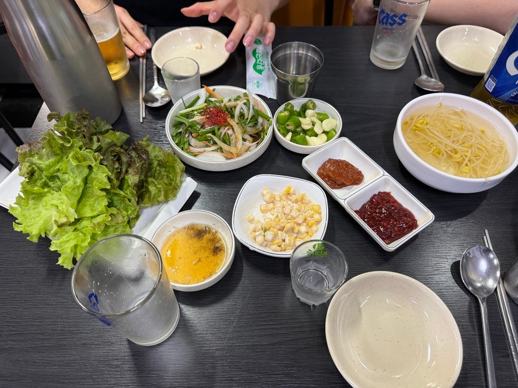 Lettuce, corn, and side dishes served before the main gopchang course