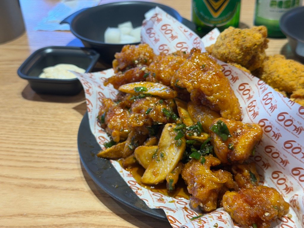 Gochu chicken coated in spicy sweet sauce with scallions