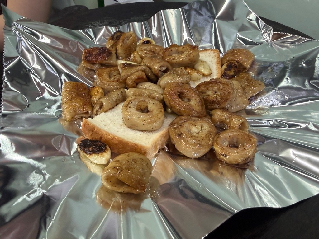 Slice of bread absorbing fat on the griddle at Yeongjane Gopchang