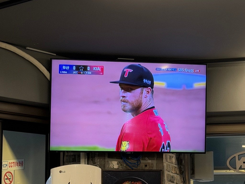 Wall-mounted TV showing a KBO baseball game inside the restaurant