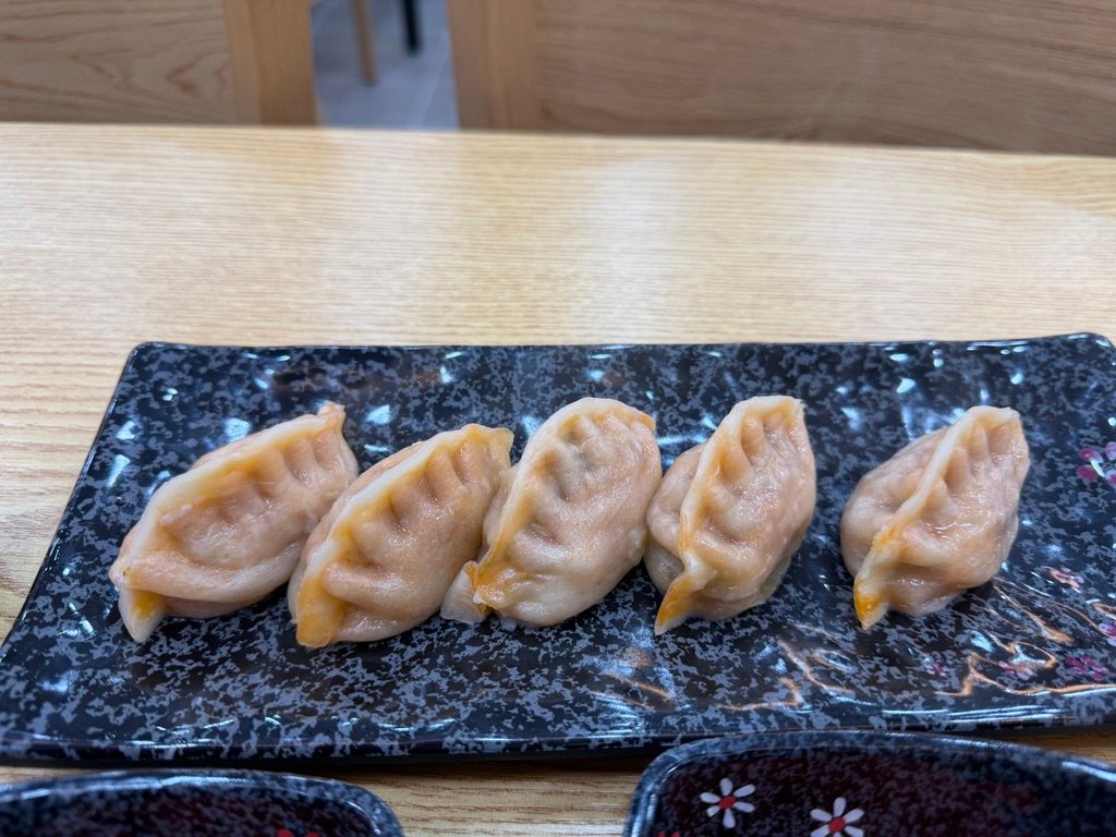 Five pieces of kimchi mandu with thin skin on a plate