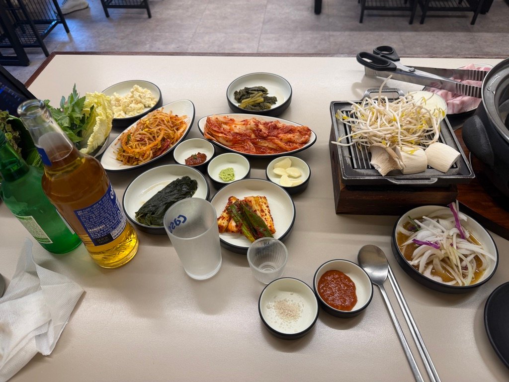 Table spread of side dishes and doenjang-jjigae at a samgyeopsal restaurant