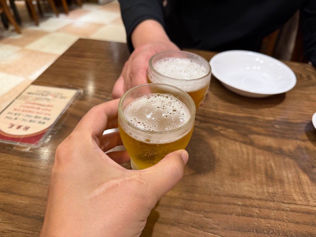 Toasting with beer glasses at a Chinese restaurant table in Seoul
