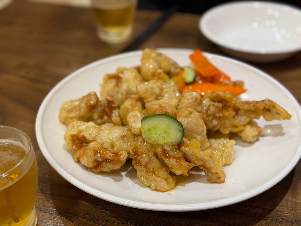Crispy tangsuyuk sweet and sour pork served with cucumber and carrot at Sillagwon