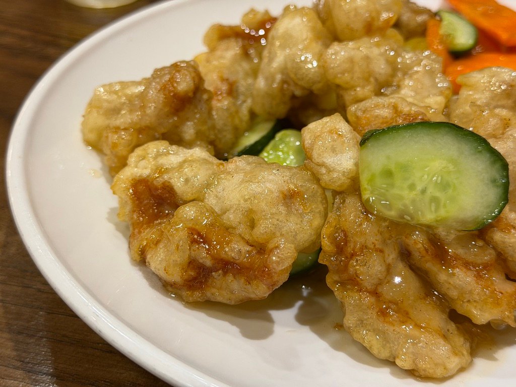 Crispy tangsuyuk sweet and sour pork served with cucumber and carrot at Sillagwon